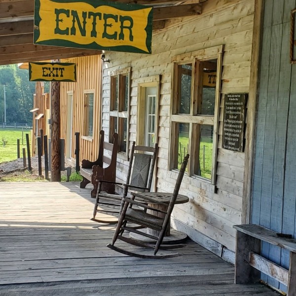An frontier style old porch with rocking chairs